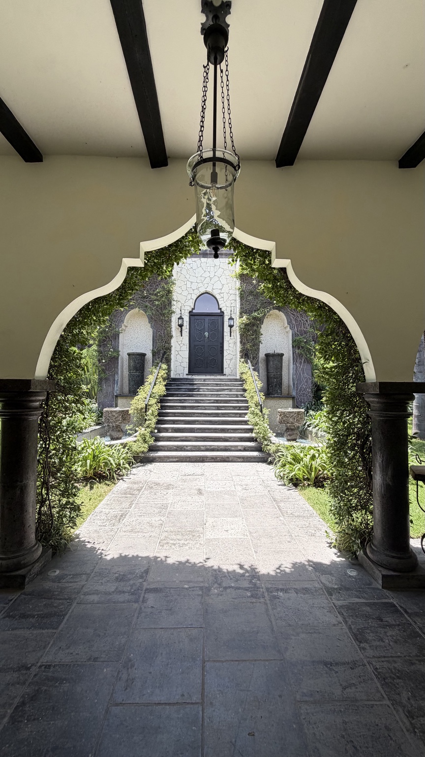 The arched garden entrance and stone walkway at Hacienda Santa Ana